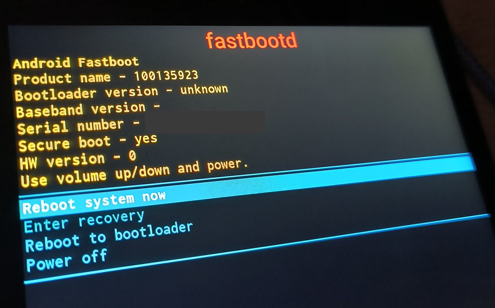 The tablet's own fastbootd screen, still reporting "Secure boot - yes" in yellow. The serial-number line is covered by an opaque bar.